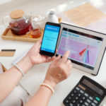 Woman shopping online and paying for purchases with banking application on smartphone