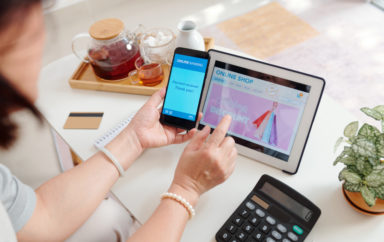 Woman shopping online and paying for purchases with banking application on smartphone